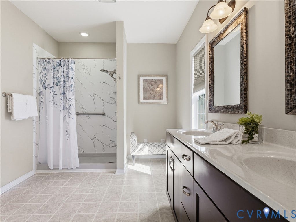 11037 Vogel Court, Bellshire, North Chesterfield, VA 23236 Dual-sink vanity with a quartz countertop, walk-in shower featuring patterned wall surrounds, recessed lighting, and tile flooring