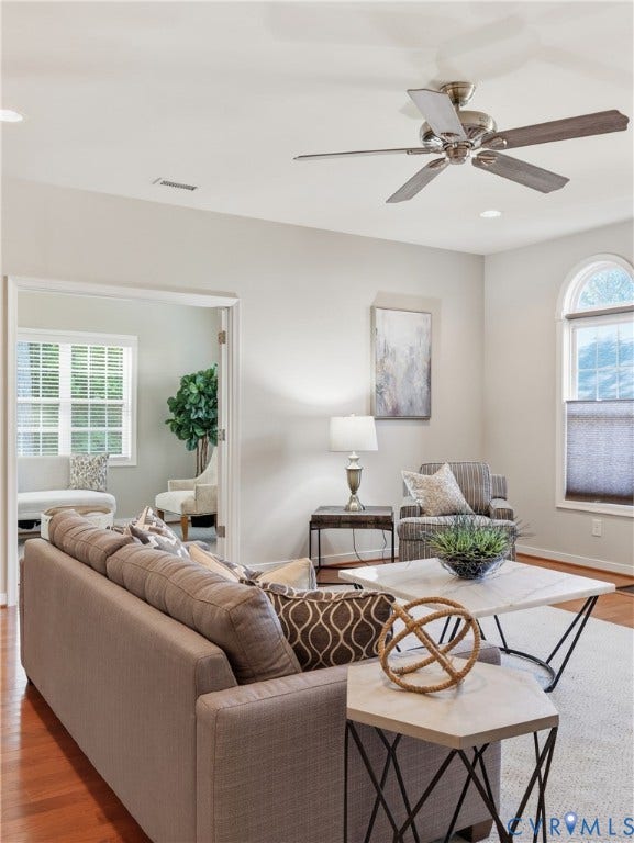11037 Vogel Court, Bellshire, North Chesterfield, VA 23236 Living area featuring wood-finish flooring, an arched window with millwork casing, a ceiling fan with integrated lighting, and French doors