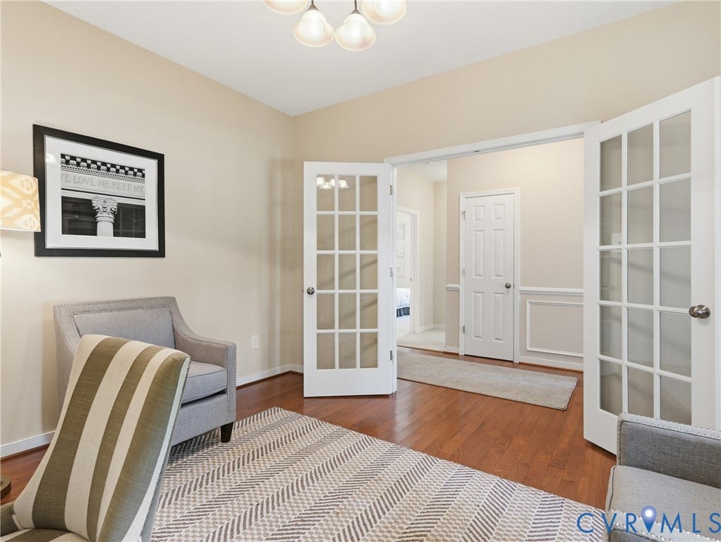 11037 Vogel Court, Bellshire, North Chesterfield, VA 23236 Room featuring wood-finish flooring, white French doors with glass panes, and wainscoting detail