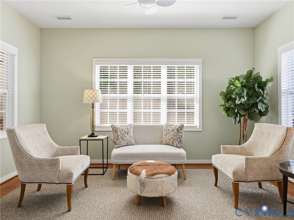 11037 Vogel Court, Bellshire, North Chesterfield, VA 23236 Spacious room featuring high ceilings, wood-finish flooring, and expansive windows fitted with plantation shutters