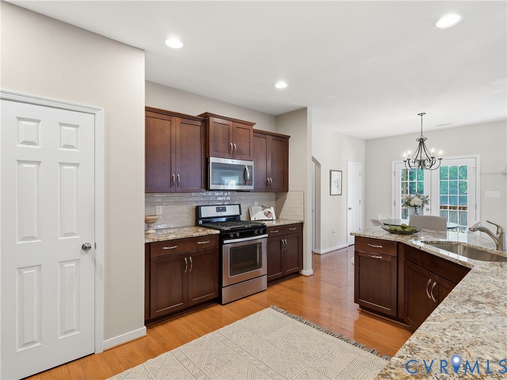 11037 Vogel Court, Bellshire, North Chesterfield, VA 23236 Kitchen featuring stained wood cabinetry, stone countertops, stainless steel appliances, wood-finish flooring, and recessed lighting