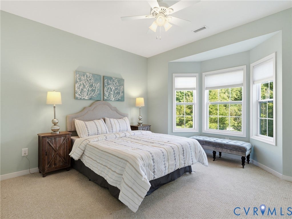 11037 Vogel Court, Bellshire, North Chesterfield, VA 23236 Bedroom featuring neutral carpeting, a triple-panel bay window, and a ceiling-mounted fan with integrated light fixture