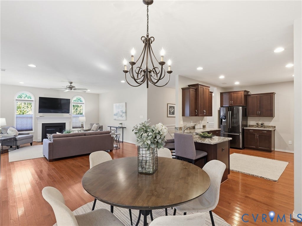 11037 Vogel Court, Bellshire, North Chesterfield, VA 23236 Open-concept interior featuring wood-finish flooring, dark wood cabinetry, stone countertops, a fireplace with a mantel, and recessed lighting