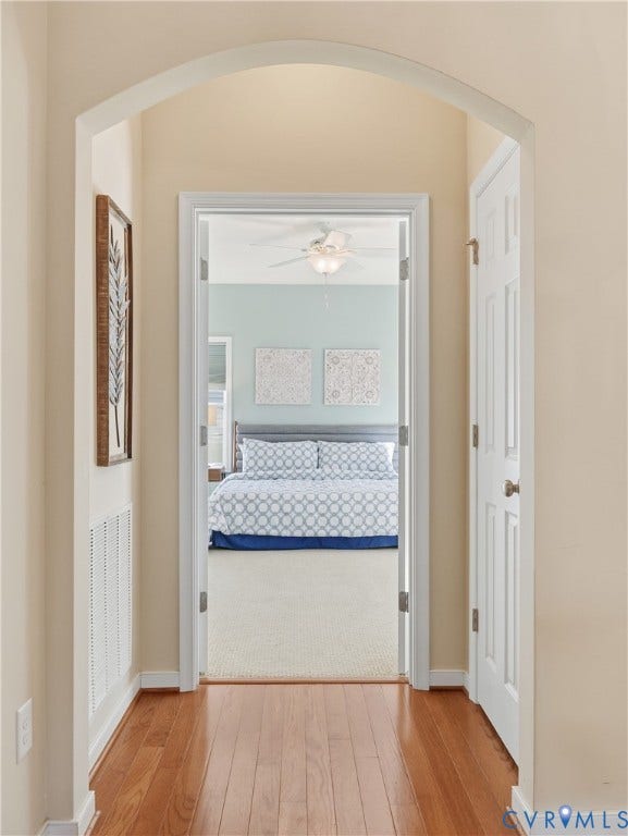 11037 Vogel Court, Bellshire, North Chesterfield, VA 23236 Arched entryway featuring wood-finish flooring, white panel doors, and a neutral color palette
