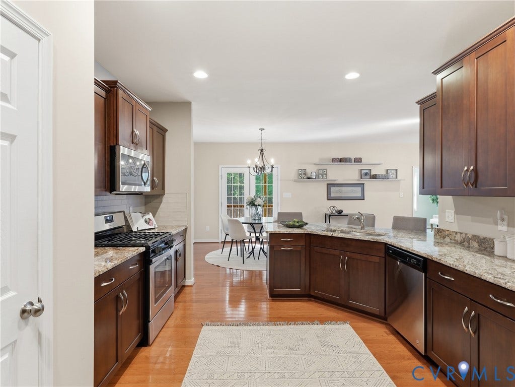 11037 Vogel Court, Bellshire, North Chesterfield, VA 23236 Kitchen featuring rich-tone cabinetry, stone-surface countertops, stainless steel appliances, and wood-finish flooring