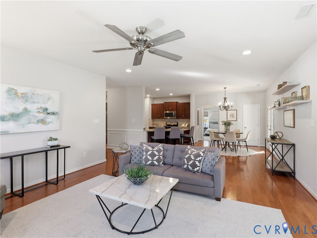 11037 Vogel Court, Bellshire, North Chesterfield, VA 23236 Open floor plan featuring wood-finish flooring, recessed lighting, brushed nickel ceiling fan, built-in wall shelving, and kitchen cabinetry with a center island