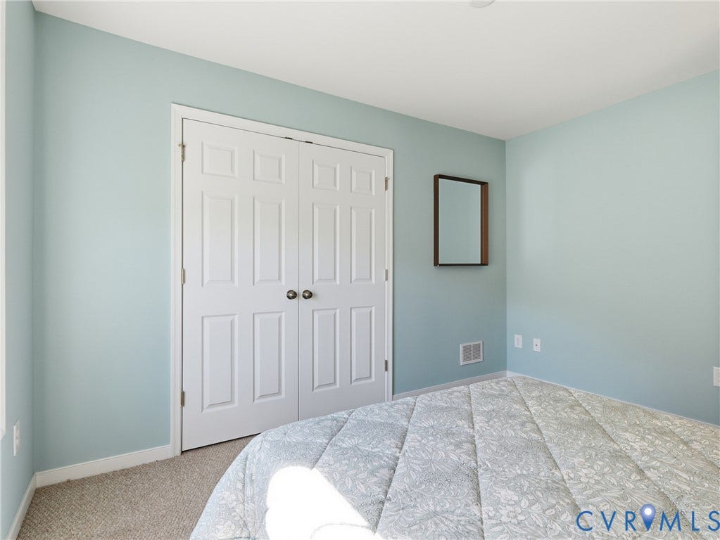 11037 Vogel Court, Bellshire, North Chesterfield, VA 23236 Double-door closet featuring a white six-panel design and carpeted flooring