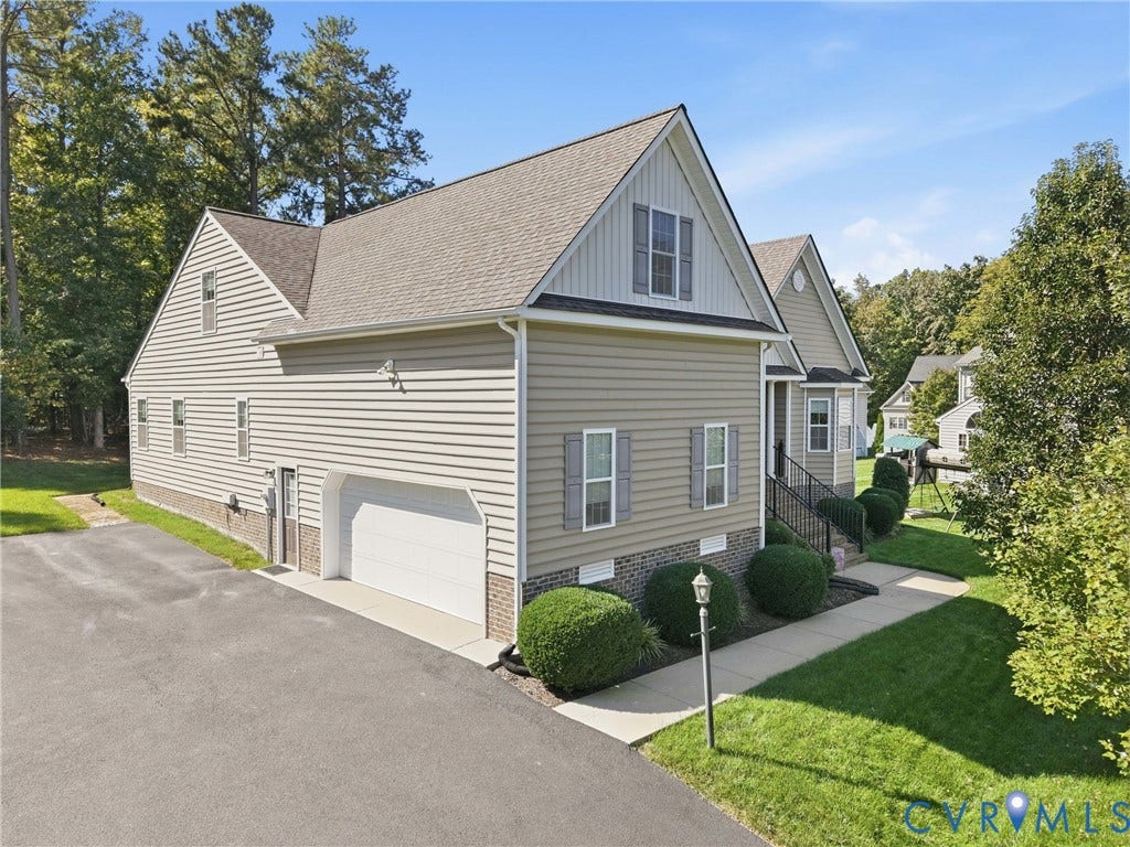 11037 Vogel Court, Bellshire, North Chesterfield, VA 23236 Two-story residence featuring horizontal lap siding, a brick foundation facade, an attached garage, and a concrete walkway
