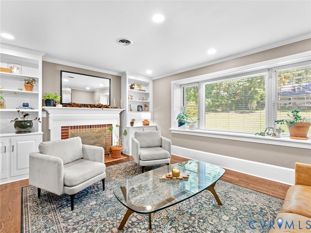 8341 Charlise Road, Stratford Hills, Midlothian, VA 23235 Living area featuring a brick-surround fireplace with a white mantel, built-in shelving, expansive picture window, recessed lighting, and wood-finish flooring