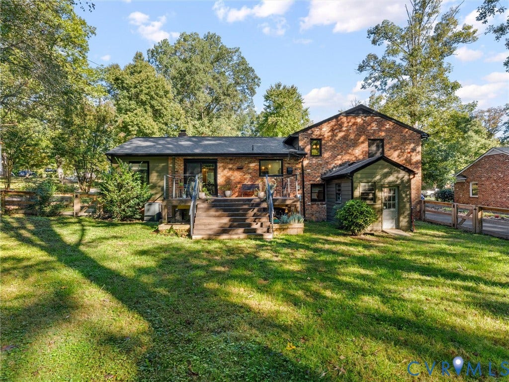 8341 Charlise Road, Stratford Hills, Midlothian, VA 23235 Multi-level brick exterior featuring a raised wood deck with staircase, expansive lawn, and fenced perimeter