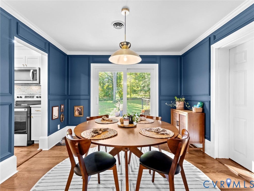 8341 Charlise Road, Stratford Hills, Midlothian, VA 23235 Dining area featuring decorative wall molding, hardwood flooring, a central pendant light fixture, and sliding glass doors