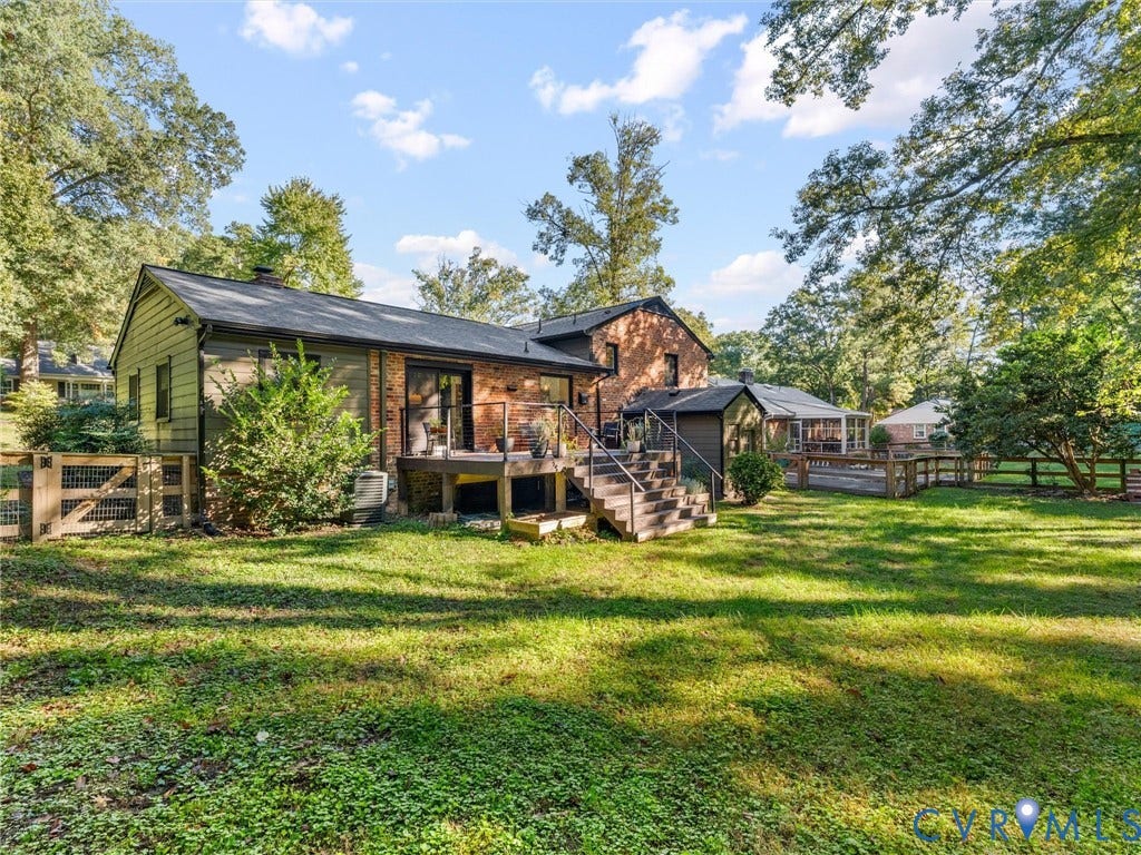 8341 Charlise Road, Stratford Hills, Midlothian, VA 23235 Rear exterior featuring a multi-level wood deck, brick and horizontal siding facade, metal railing, and a fenced yard with mature trees