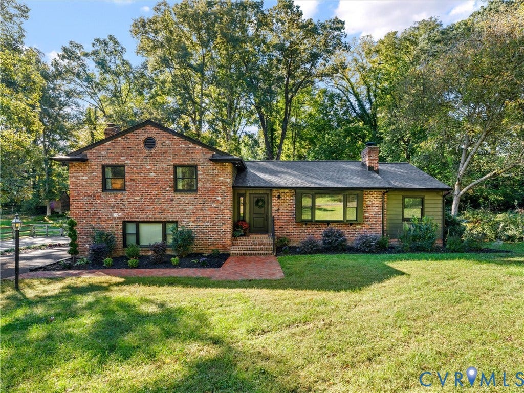 8341 Charlise Road, Stratford Hills, Midlothian, VA 23235 Multi-level brick exterior featuring a shingled roof, horizontal siding accents, an integrated chimney, and a brick walkway