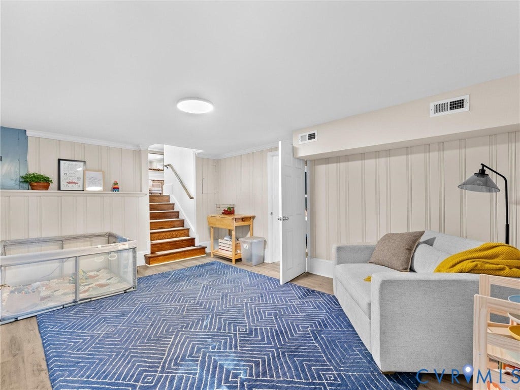 8341 Charlise Road, Stratford Hills, Midlothian, VA 23235 Finished interior space featuring vertical wall paneling, wood-finish flooring, and a staircase with stained wood treads