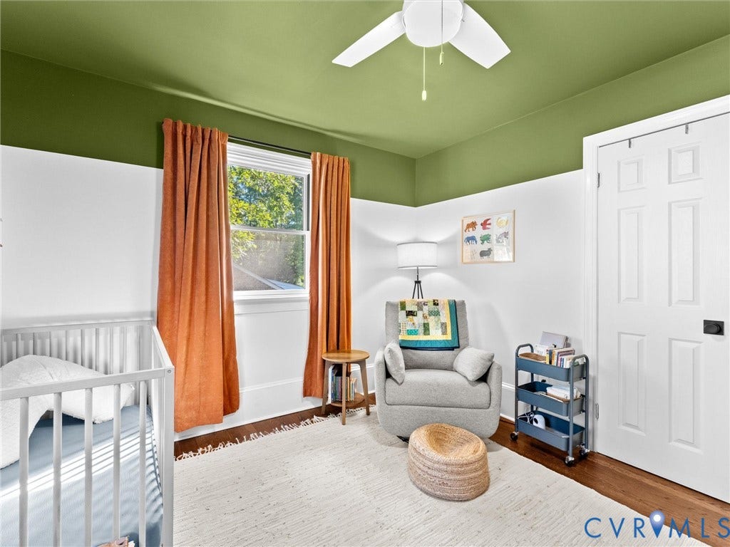 8341 Charlise Road, Stratford Hills, Midlothian, VA 23235 Hardwood flooring, two-toned wall paint, white six-panel interior door, and a white ceiling fan with integrated lighting
