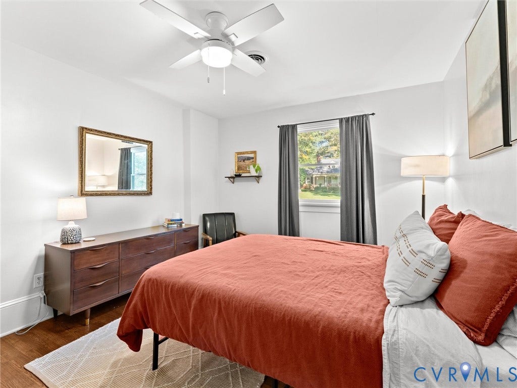 8341 Charlise Road, Stratford Hills, Midlothian, VA 23235 Neutral-toned room featuring wood-finish flooring, a white ceiling fan with integrated lighting, and a single-pane window with architectural trim