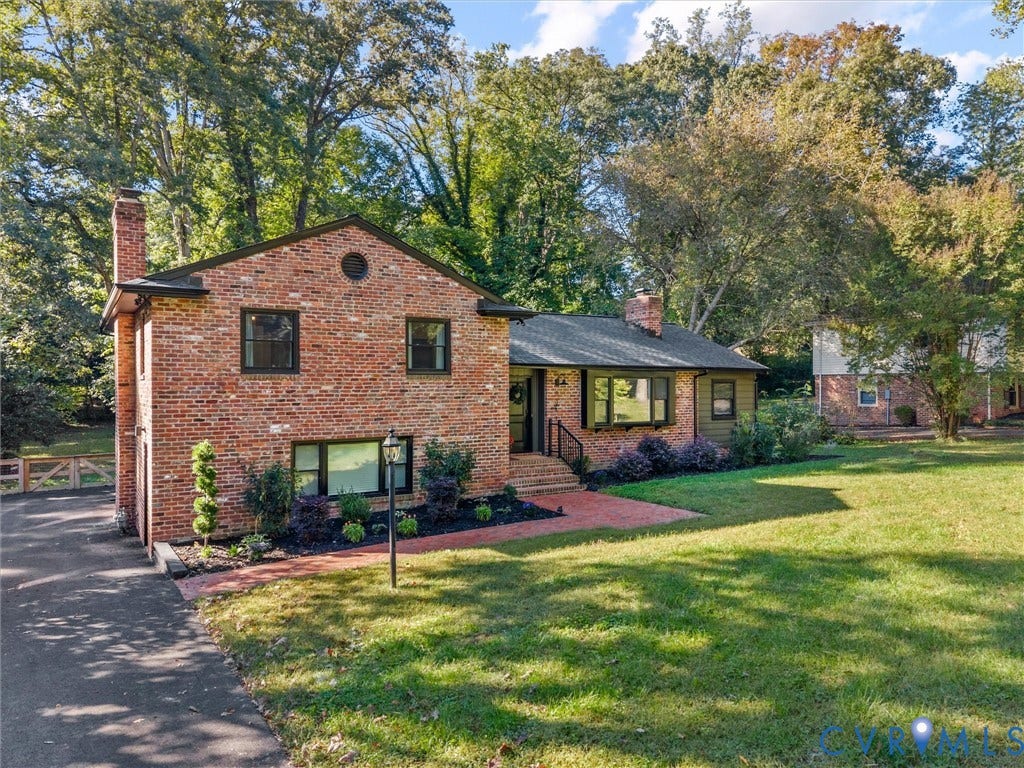 8341 Charlise Road, Stratford Hills, Midlothian, VA 23235 Classic brick exterior featuring a multi-level roofline, a bay window, a paved walkway, and mature landscaping
