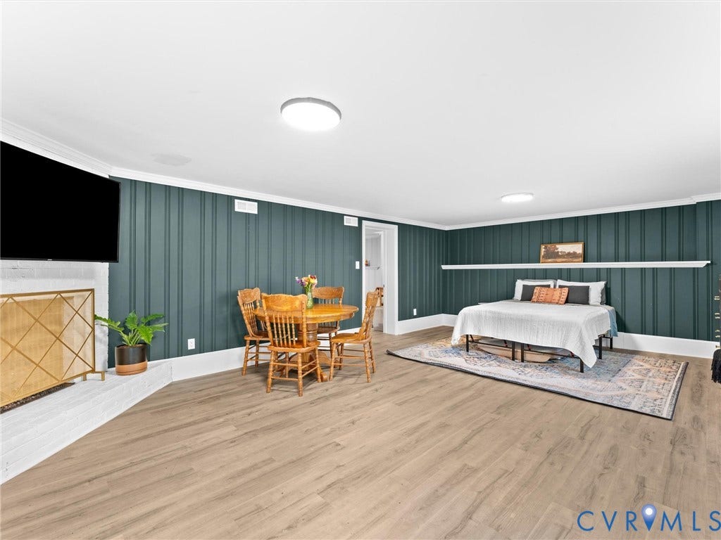 8341 Charlise Road, Stratford Hills, Midlothian, VA 23235 Vertical plank wall paneling, wood-finish flooring, white brick fireplace surround, and built-in mantle ledge