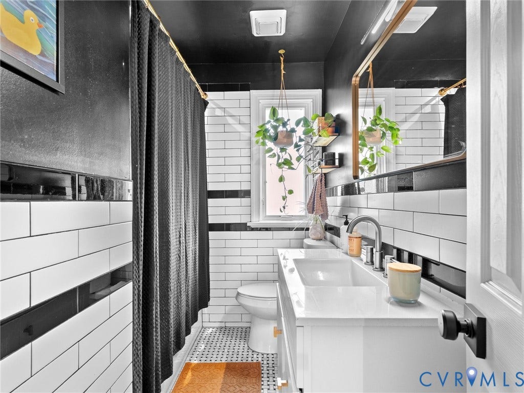 8341 Charlise Road, Stratford Hills, Midlothian, VA 23235 Bathroom featuring white subway tile walls with black accent banding, a floating white vanity with an integrated basin, a gold-framed rectangular mirror, and mosaic tile flooring