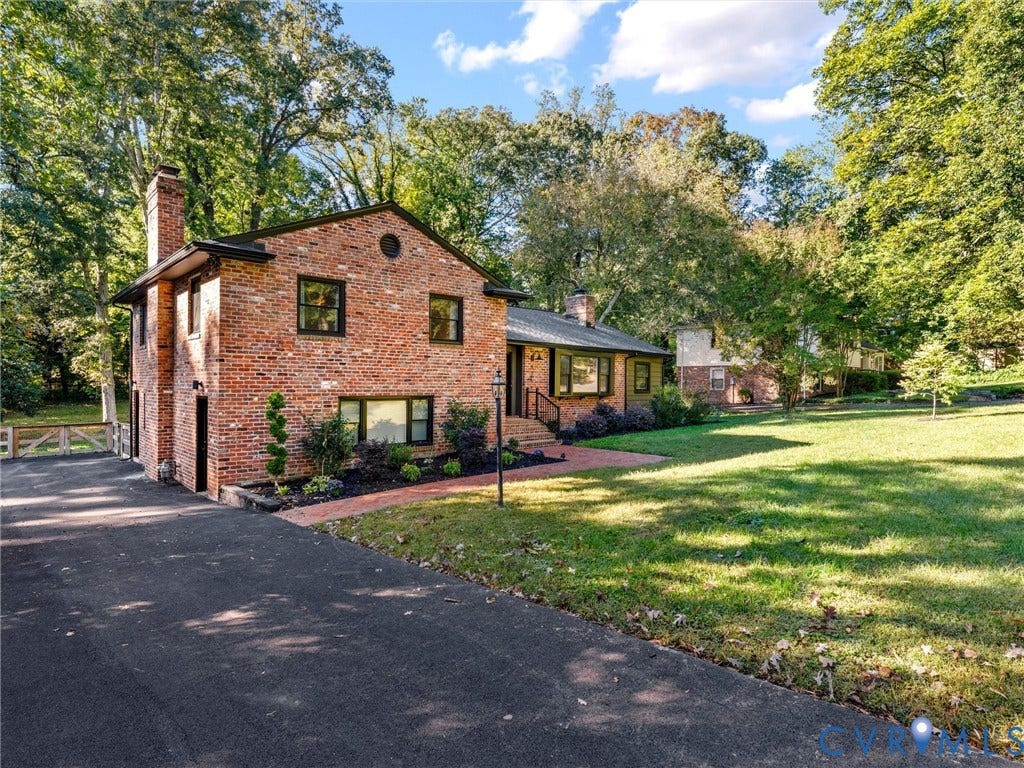 8341 Charlise Road, Stratford Hills, Midlothian, VA 23235 Two-story brick exterior featuring a chimney, asphalt driveway, brick walkway, and mature landscaping