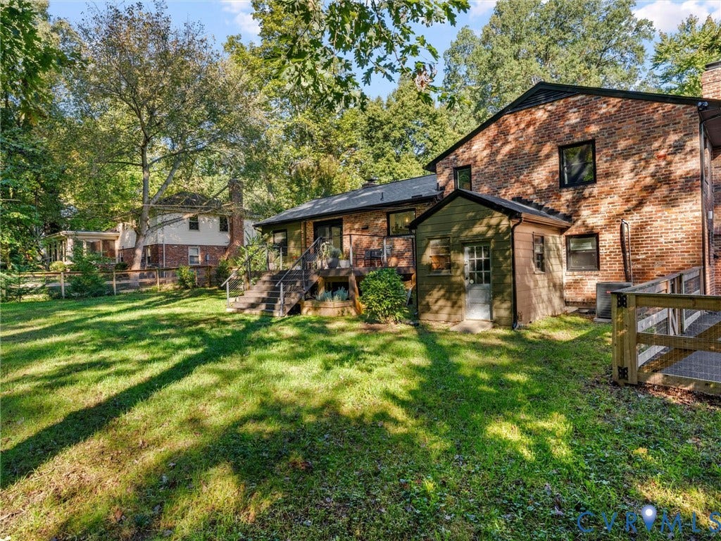8341 Charlise Road, Stratford Hills, Midlothian, VA 23235 Brick exterior featuring a multi-level wood deck, side addition, and mature trees on a level lot