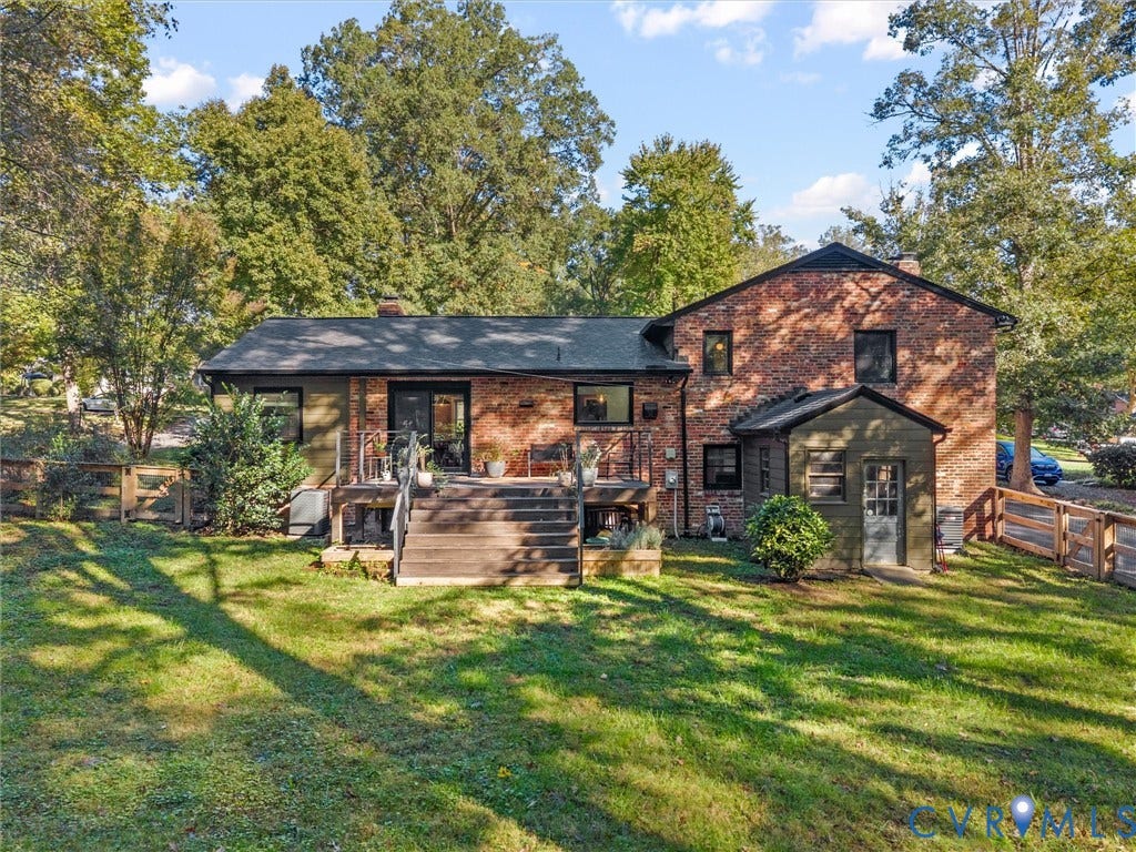 8341 Charlise Road, Stratford Hills, Midlothian, VA 23235 Brick exterior featuring a rear wood deck, multi-level roofline, fenced perimeter, and established landscaping