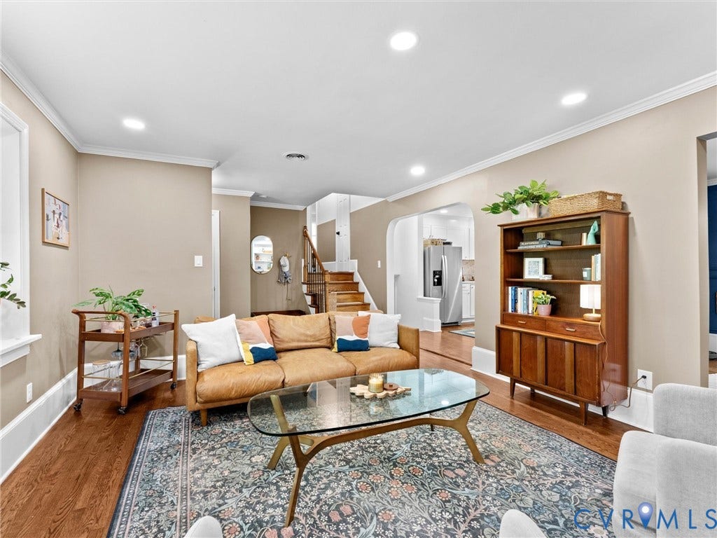 8341 Charlise Road, Stratford Hills, Midlothian, VA 23235 Living area featuring hardwood flooring, recessed lighting, and a neutral color palette, characterized by an arched entryway and a wooden staircase with a handrail