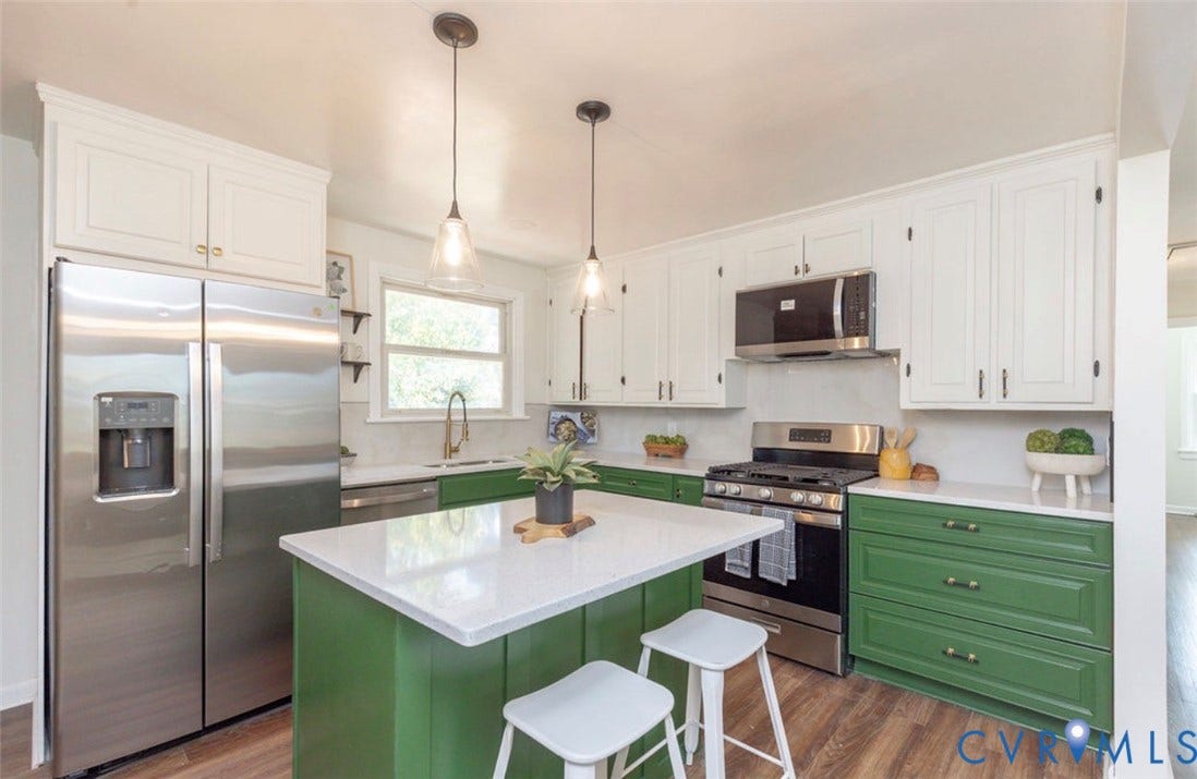 2211 Apollo Road, Fairfield, VA 23223 Kitchen featuring green and white cabinetry, stainless steel appliances, a center island with a white countertop, and wood-finish flooring