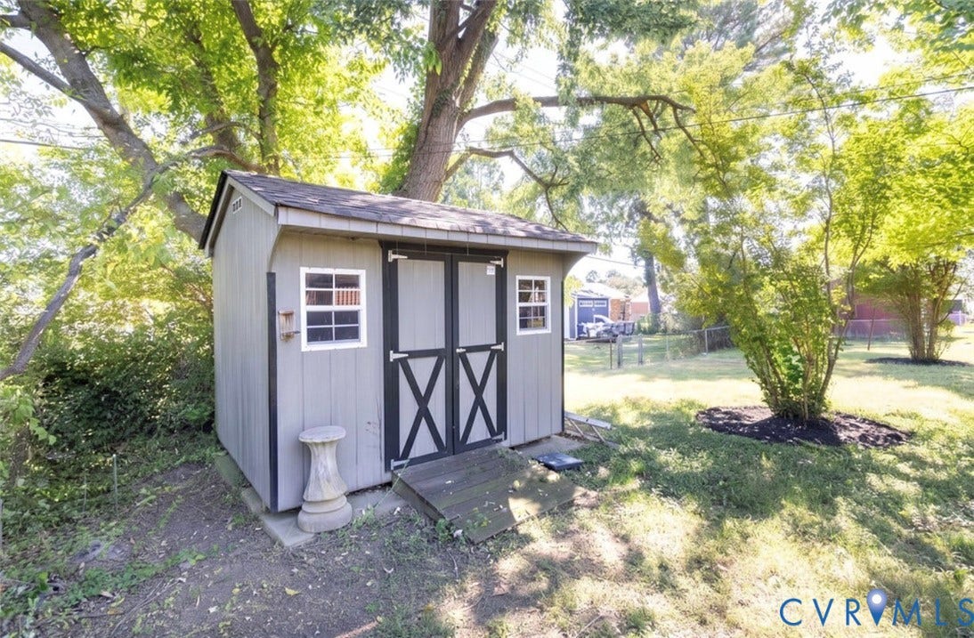 2211 Apollo Road, Fairfield, VA 23223 Exterior storage shed with a shingled roof, double barn doors, and side windows