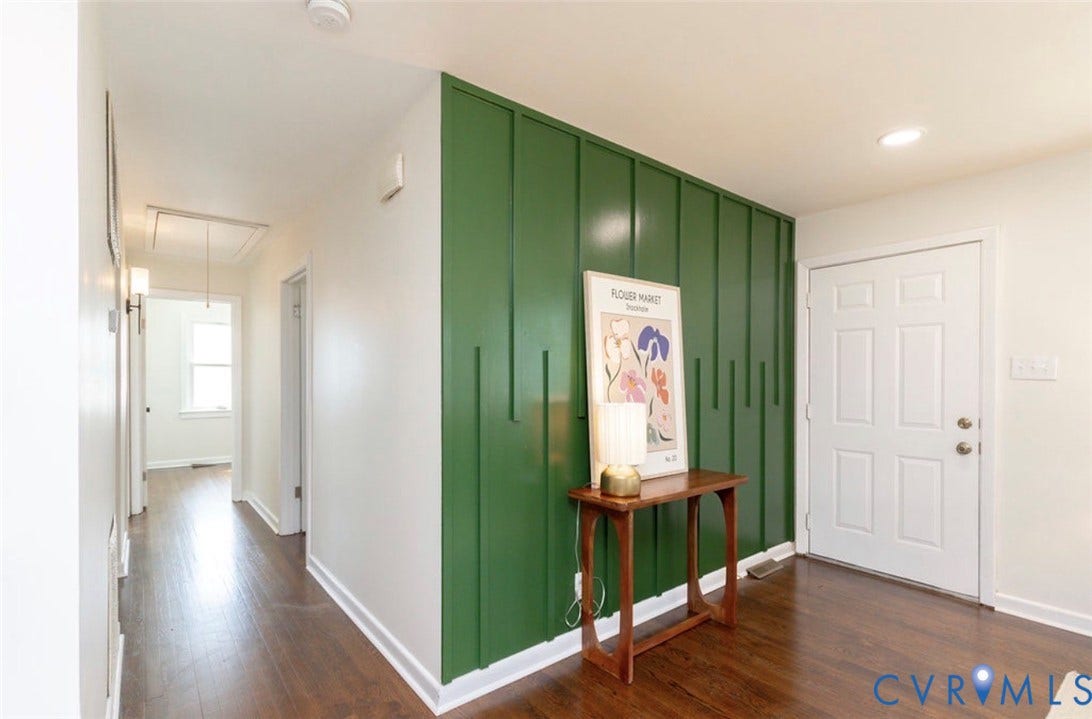 2211 Apollo Road, Fairfield, VA 23223 Accent wall with vertical paneling, recessed ceiling lighting, wood-finish flooring, and a paneled entry door
