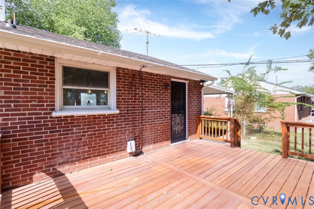 2211 Apollo Road, Fairfield, VA 23223 Red brick exterior with a wood deck, wood railings, and a security screen door