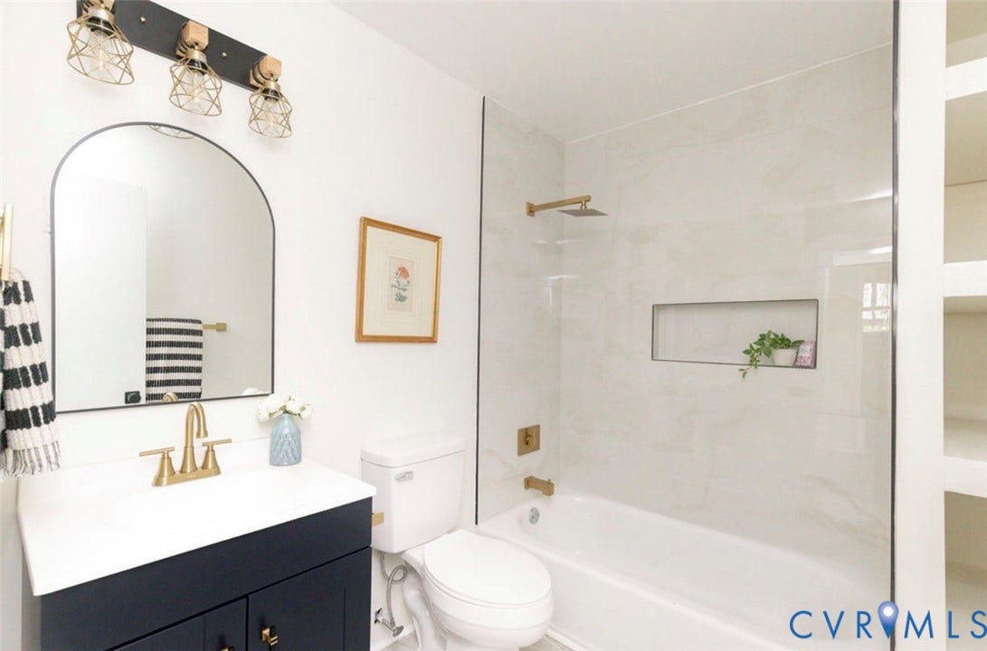 2211 Apollo Road, Fairfield, VA 23223 White vanity with a dark wood-finish base and gold-tone faucet