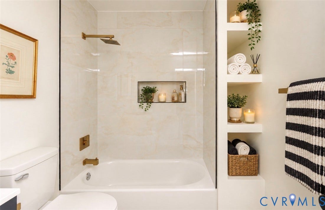 2211 Apollo Road, Fairfield, VA 23223 Bathtub with a tiled surround featuring a recessed niche, glass shower partition, and brass-finish fixtures