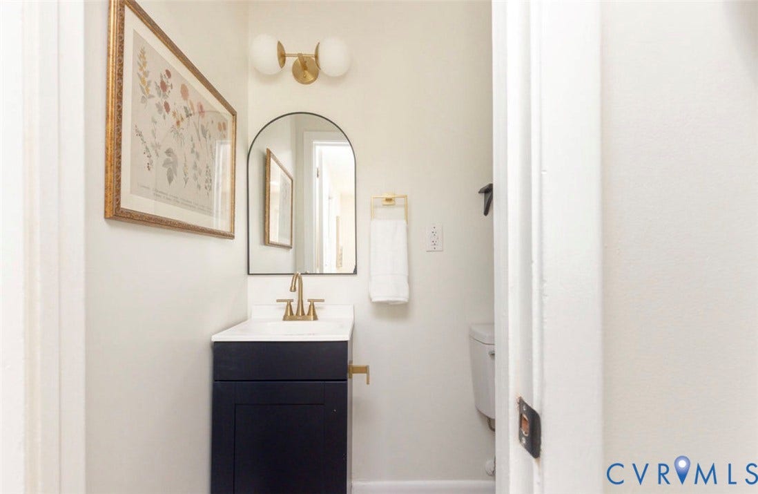 2211 Apollo Road, Fairfield, VA 23223 Vanity featuring a dark-toned cabinet with a white countertop and gold-toned faucet