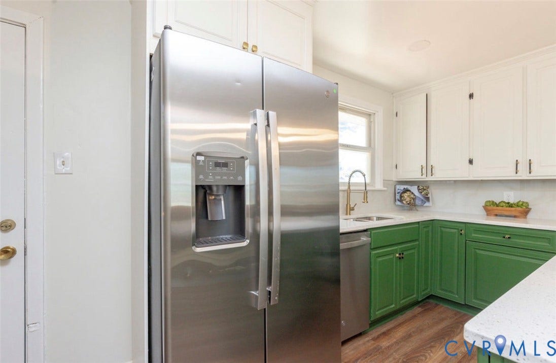 2211 Apollo Road, Fairfield, VA 23223 Stainless steel side-by-side refrigerator, two-tone cabinetry, wood-finish flooring, white countertops, and a single-basin sink with a gold-tone faucet