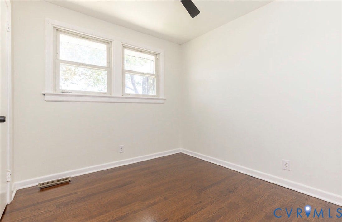 2211 Apollo Road, Fairfield, VA 23223 Wood-finish flooring with white baseboards, a ceiling fan, and two windows providing natural illumination