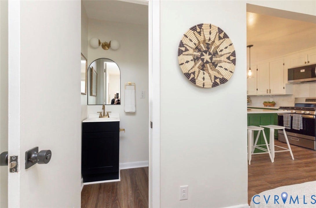 2211 Apollo Road, Fairfield, VA 23223 Powder room with an arched mirror, modern vanity, and brass-finish lighting
