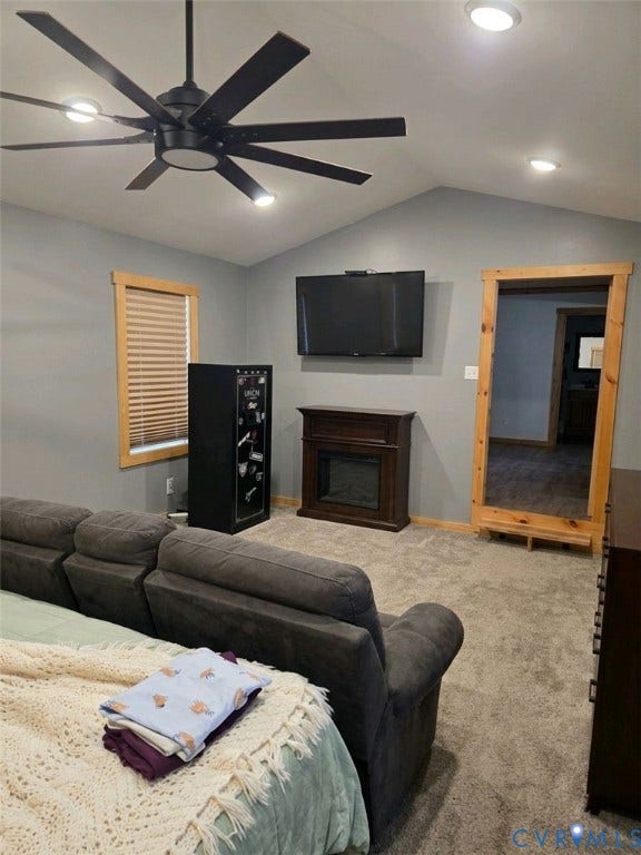 Vaulted ceiling with recessed lighting and a ceiling fan, wall-mounted television, and an electric fireplace