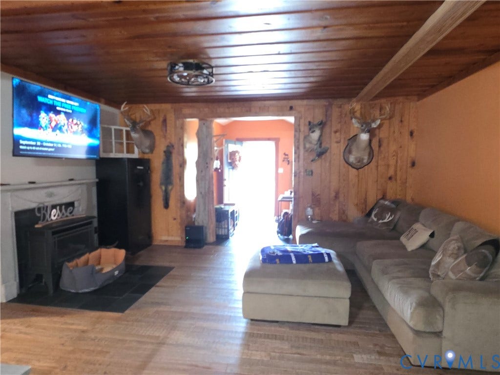 Wood-finish flooring throughout, complemented by a wood-paneled wall