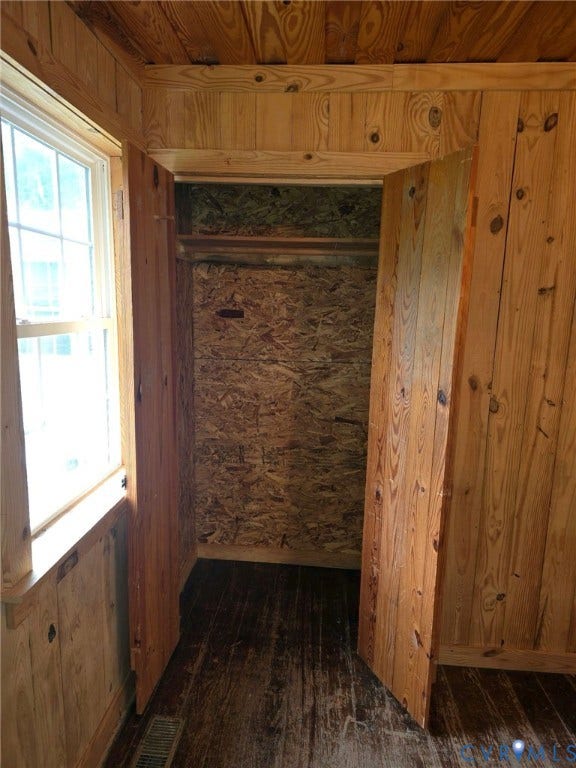 Wood-paneled walls and ceiling with a double-hung window