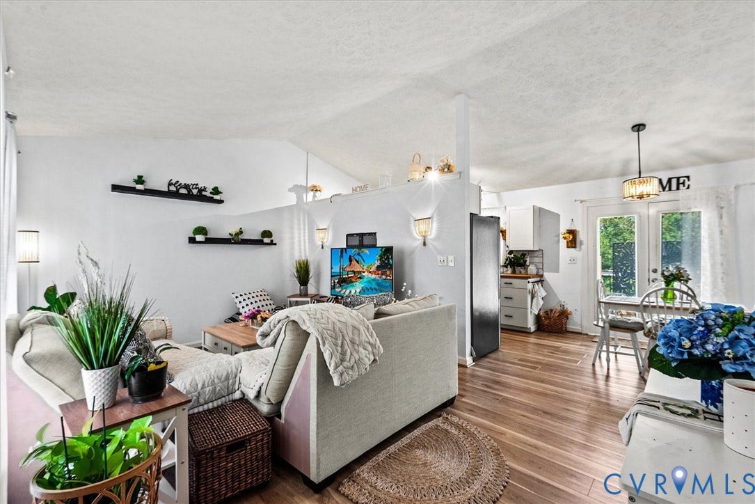 2421 Pittston Road, Ruffin's Pond, Fredericksburg, VA 22408 Vaulted ceiling with textured finish, wood-finish flooring, built-in shelving, glass-panel French doors, and a modern pendant light fixture