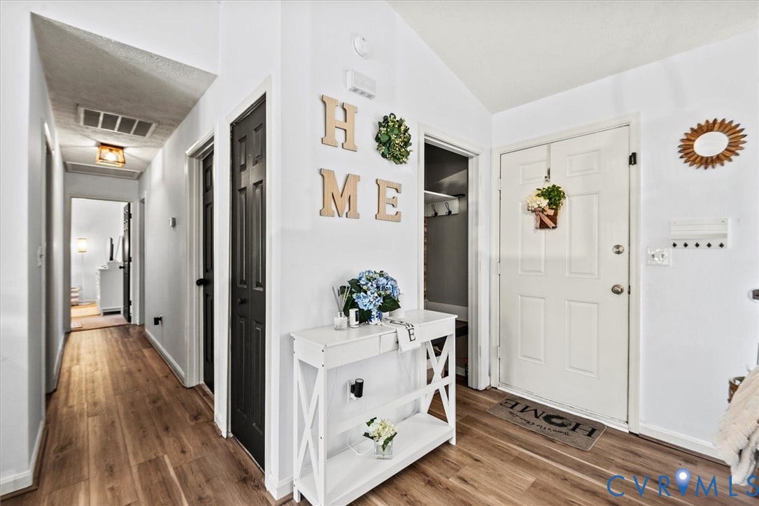 2421 Pittston Road, Ruffin's Pond, Fredericksburg, VA 22408 Entryway featuring wood-finish flooring, white paneled doors, and a vaulted ceiling
