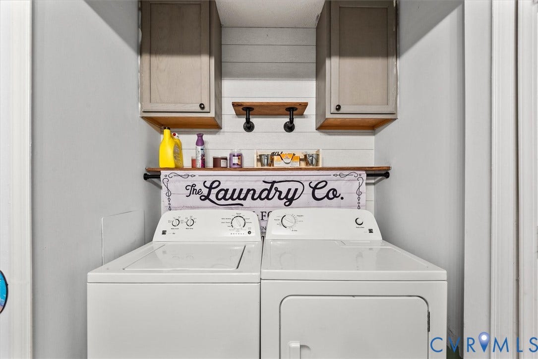 2421 Pittston Road, Ruffin's Pond, Fredericksburg, VA 22408 Laundry area featuring white shiplap wall paneling, two wood-finish floating shelves with industrial-style brackets, and upper cabinetry