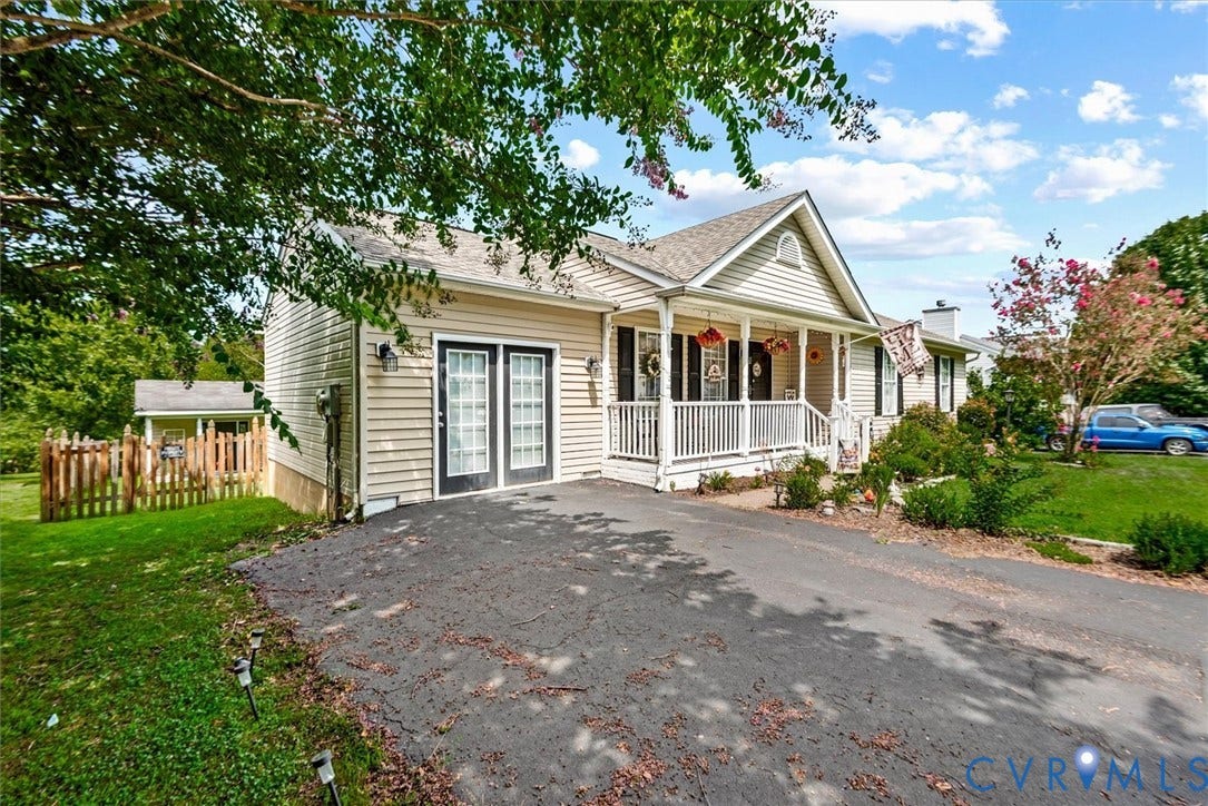 2421 Pittston Road, Ruffin's Pond, Fredericksburg, VA 22408 Vinyl siding exterior with a covered porch, white railing, and a gabled roofline