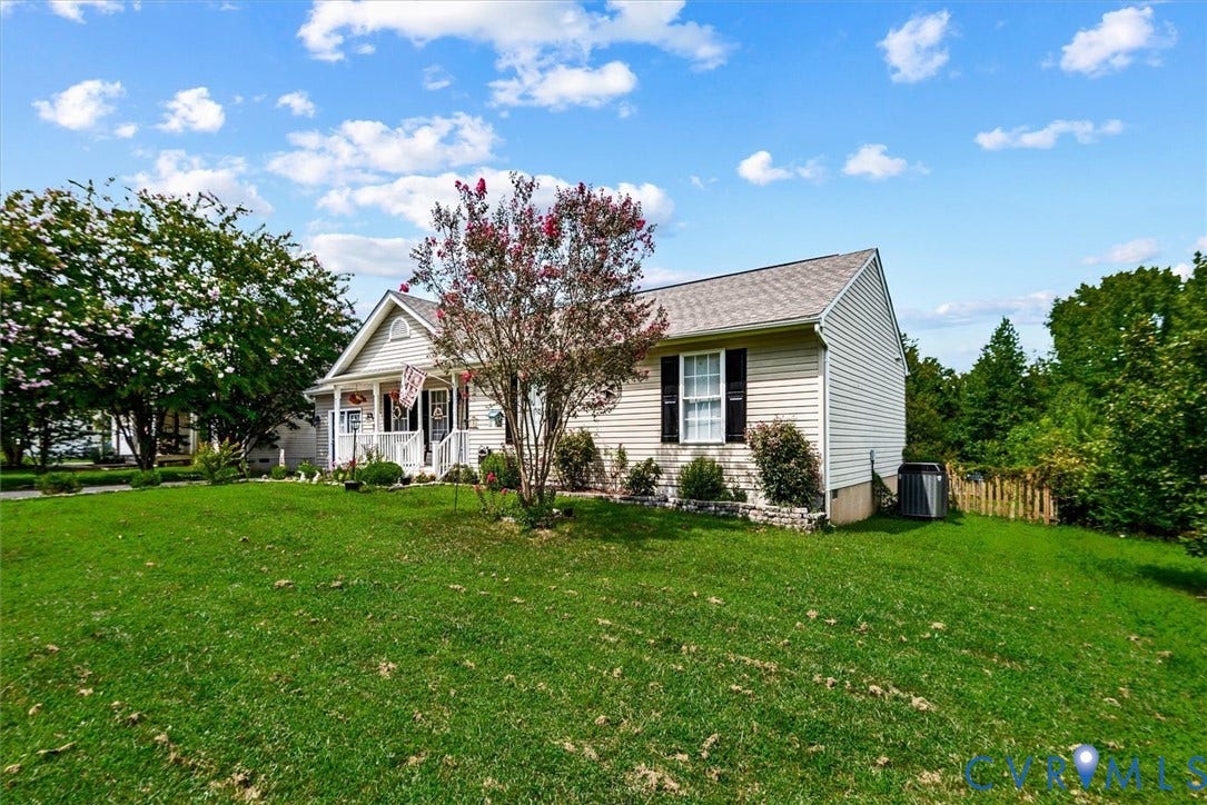 2421 Pittston Road, Ruffin's Pond, Fredericksburg, VA 22408 Gabled residence with light-colored siding, dark window shutters, and a covered porch