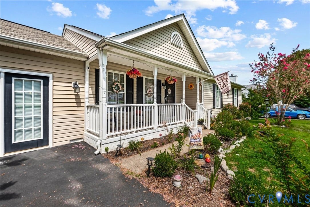 2421 Pittston Road, Ruffin's Pond, Fredericksburg, VA 22408 Light-colored siding exterior with a covered porch, white railing, and decorative shutters