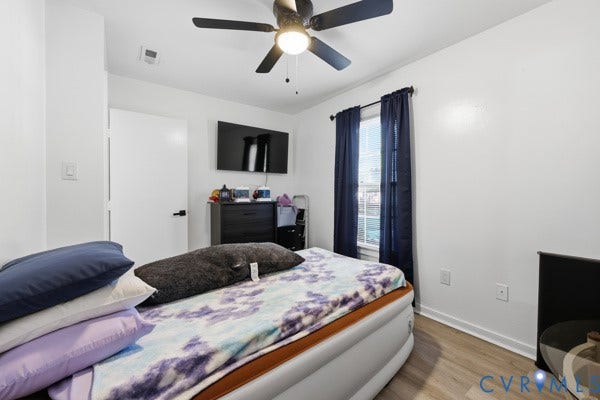 4647 Twelveoaks Road, Midlothian, VA 23112 Room featuring wood-finish flooring, a matte black ceiling fan with integrated lighting, and a window with a mounted curtain rod