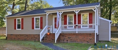 4647 Twelveoaks Road, Midlothian, VA 23112 Single-story residence featuring light-toned vinyl siding, a red brick foundation, a covered front porch with white railing, and decorative red window shutters