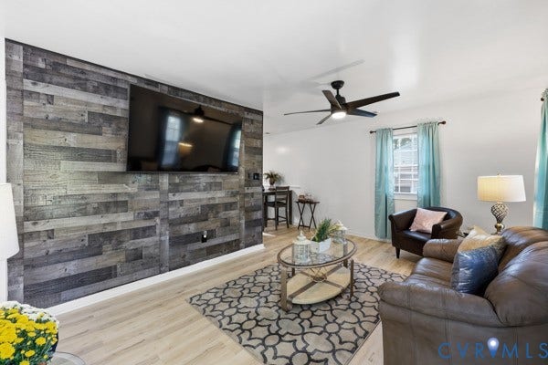 4647 Twelveoaks Road, Midlothian, VA 23112 Accent wall featuring horizontal weathered wood-finish paneling, wood-finish flooring, and a ceiling-mounted fan with integrated lighting