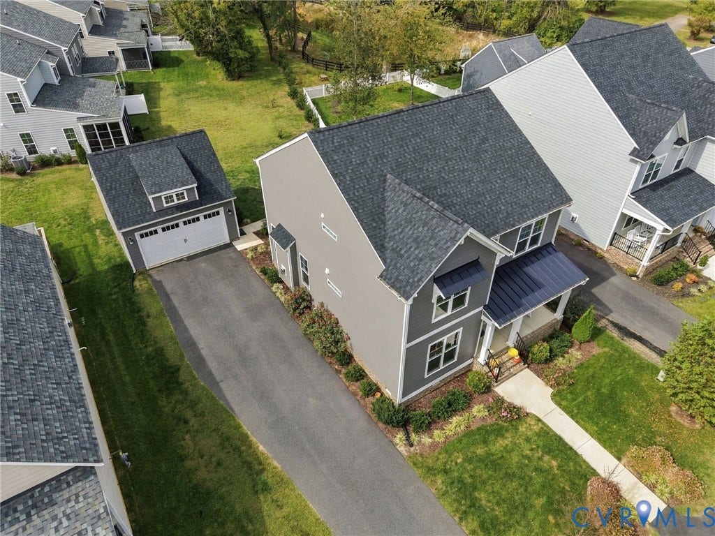 Two-story residence with dark gray siding and white trim